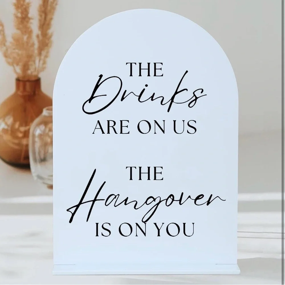 Black and white Wedding sign. The drinks are on us the hangover is on you